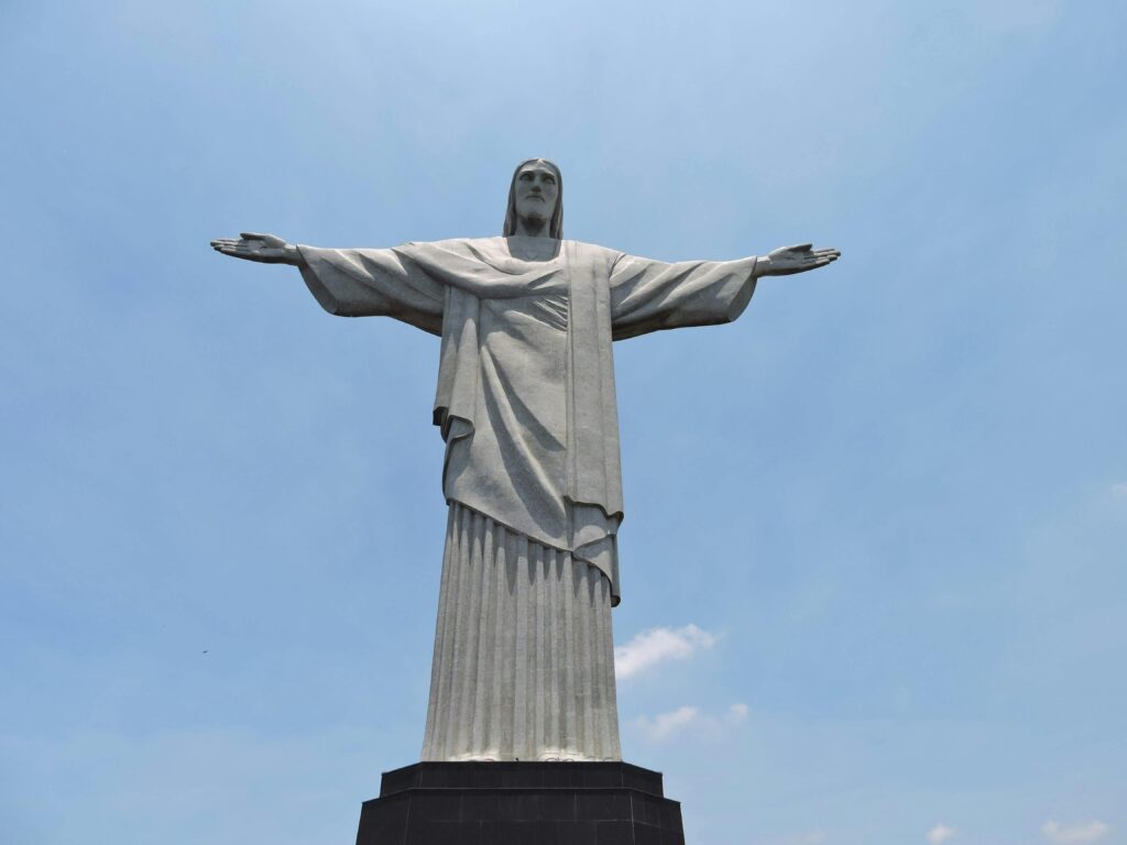 Iconic Christ the Redeemer statue under a clear sky in Rio de Janeiro, Brazil.